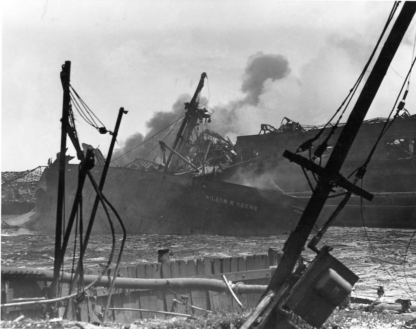 A wrecked smoking ship in the background, destruction in foreground A wrecked smoking ship in the background, destruction in foreground